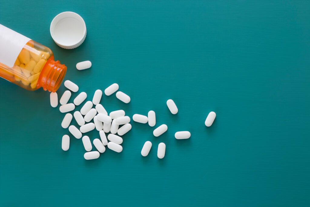 white pills on teal background